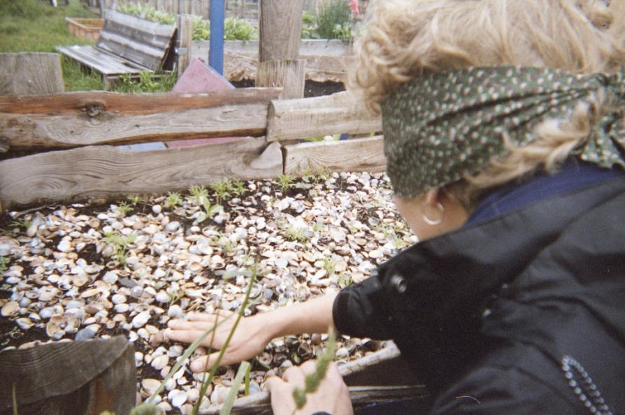 A participant explores a bed of shells with her hands during a blindfolded tour of the Rübezahl community gardens.
